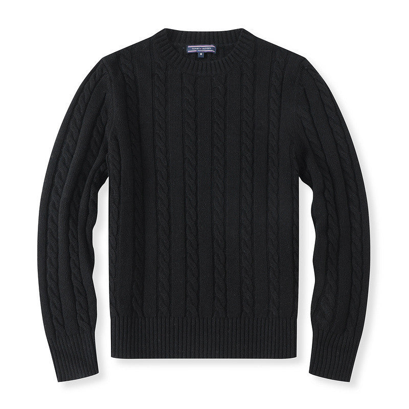 Black cable knit sweater on a white background